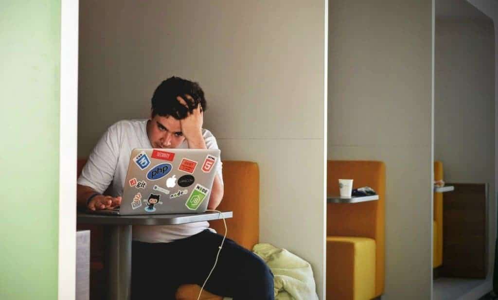Man Sitting At Computer Stressed