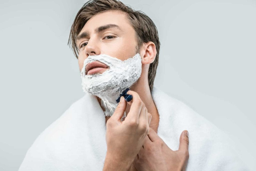 Man Shaving Face with Razor