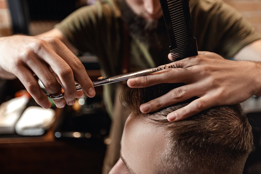 Men's haircut with scissors and comb at 18|8 Fine Men's Salons in 4S Ranch