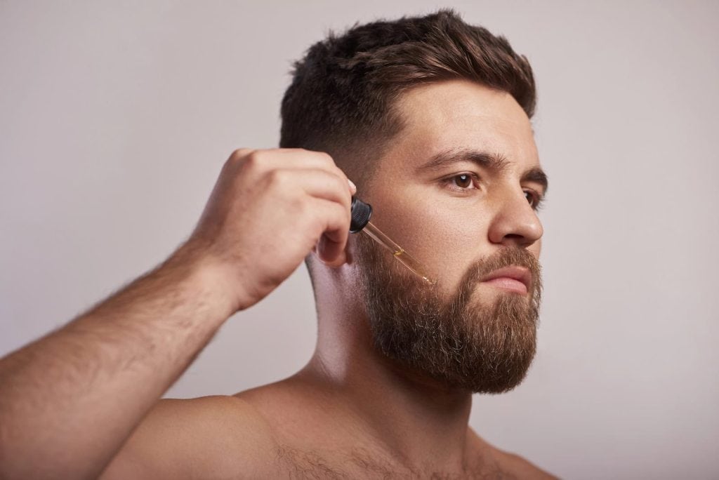 Man Applying Beard Oil