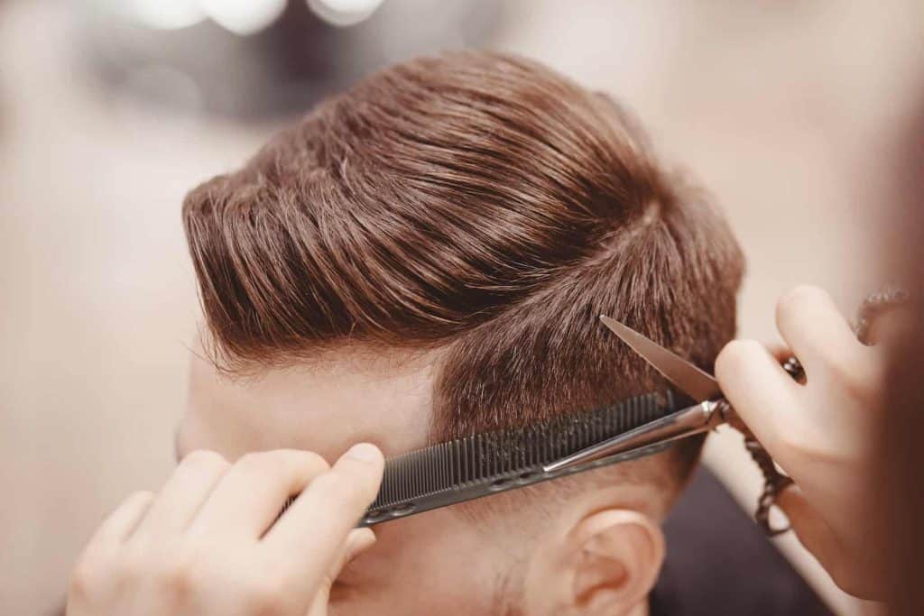Close up on man getting his hair cut