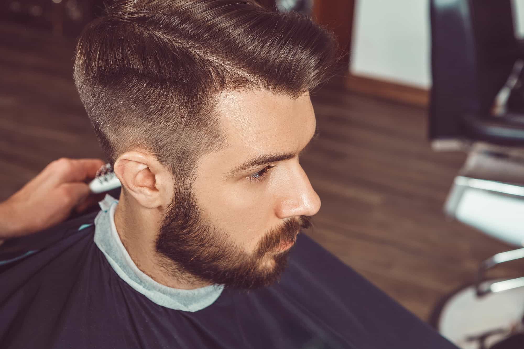 Man at a barbershop getting groomed