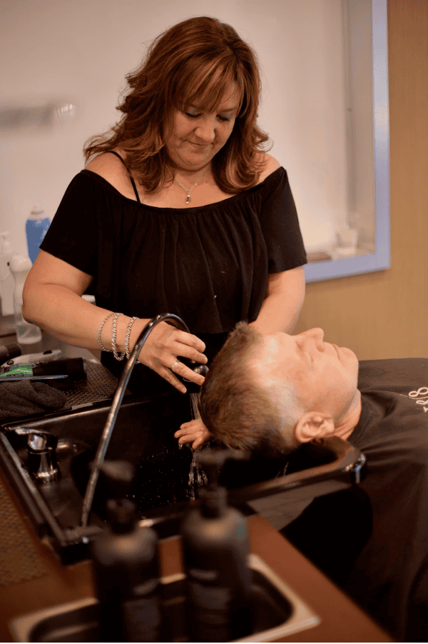 Color application at the shampoo bowl at 18|8 Fine Men's Salons