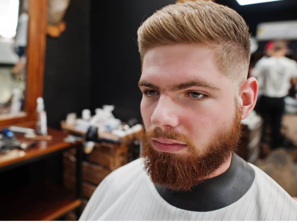 Man in the barbershop after getting a low-fade haircut