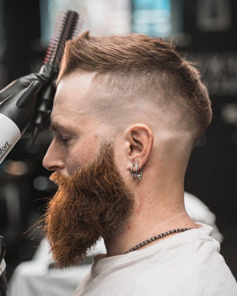 Man with a skin fade haircut at the barber
